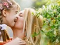 Young girl with a disability is embraced by her mother